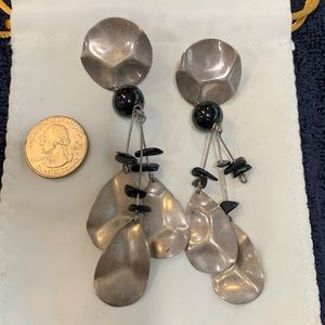 Dangling faux silver earrings.